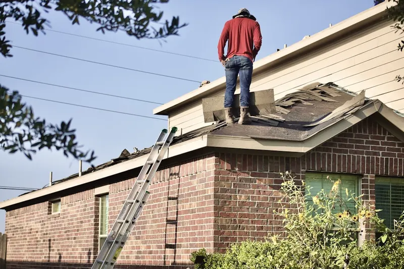 Professional roofer working on a residential roof in Oak Square